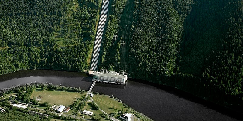 Wasserkraftwerk mit Staumauer und umliegendem Wald aus der Vogelperspektive. Foto: Rainer Weisflog. Wasserkraftwerk mit Staumauer und umliegendem Wald aus der Vogelperspektive. Foto: Rainer Weisflog.