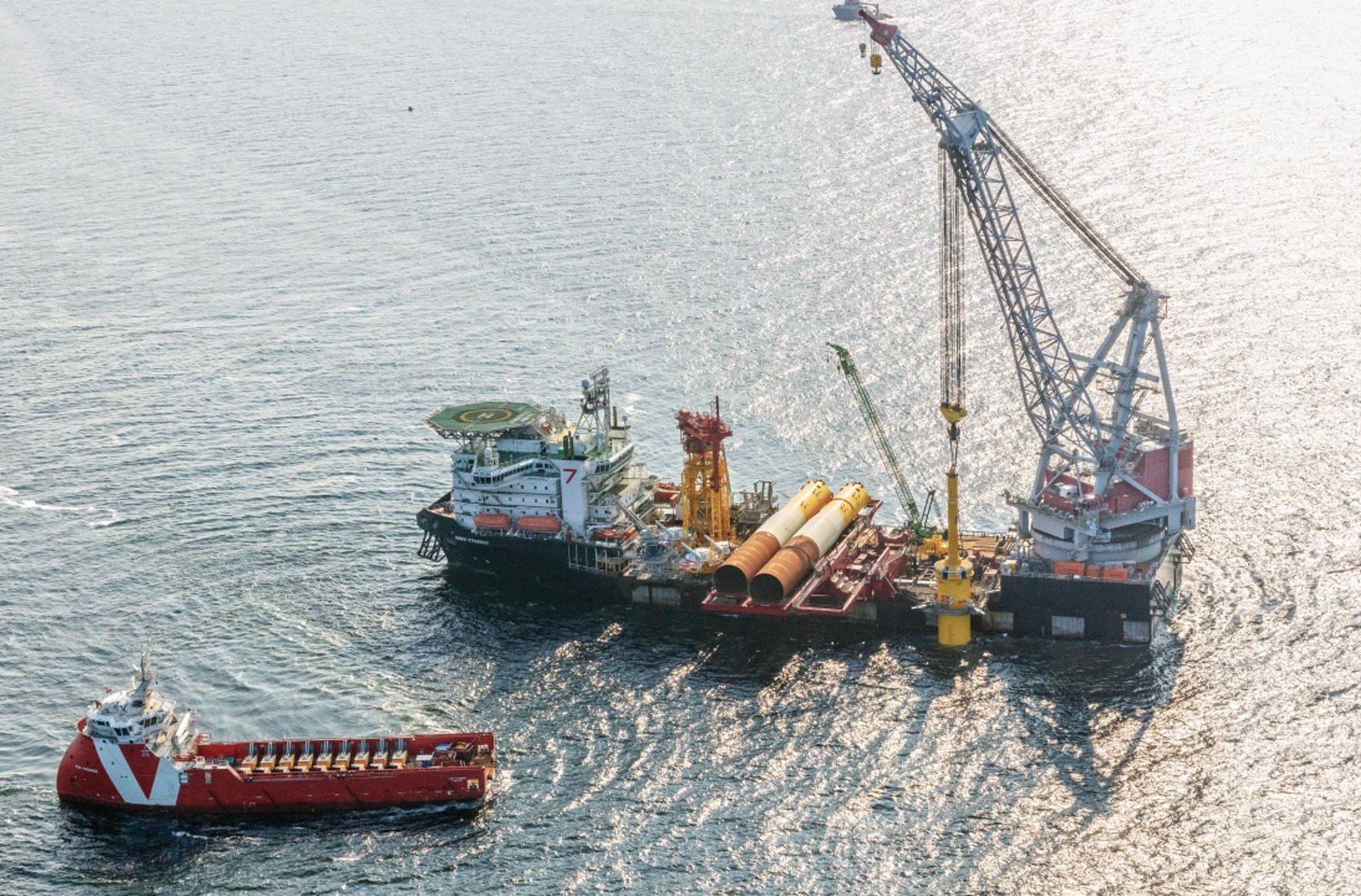 Offshore wind vessels installing equipment at sea.