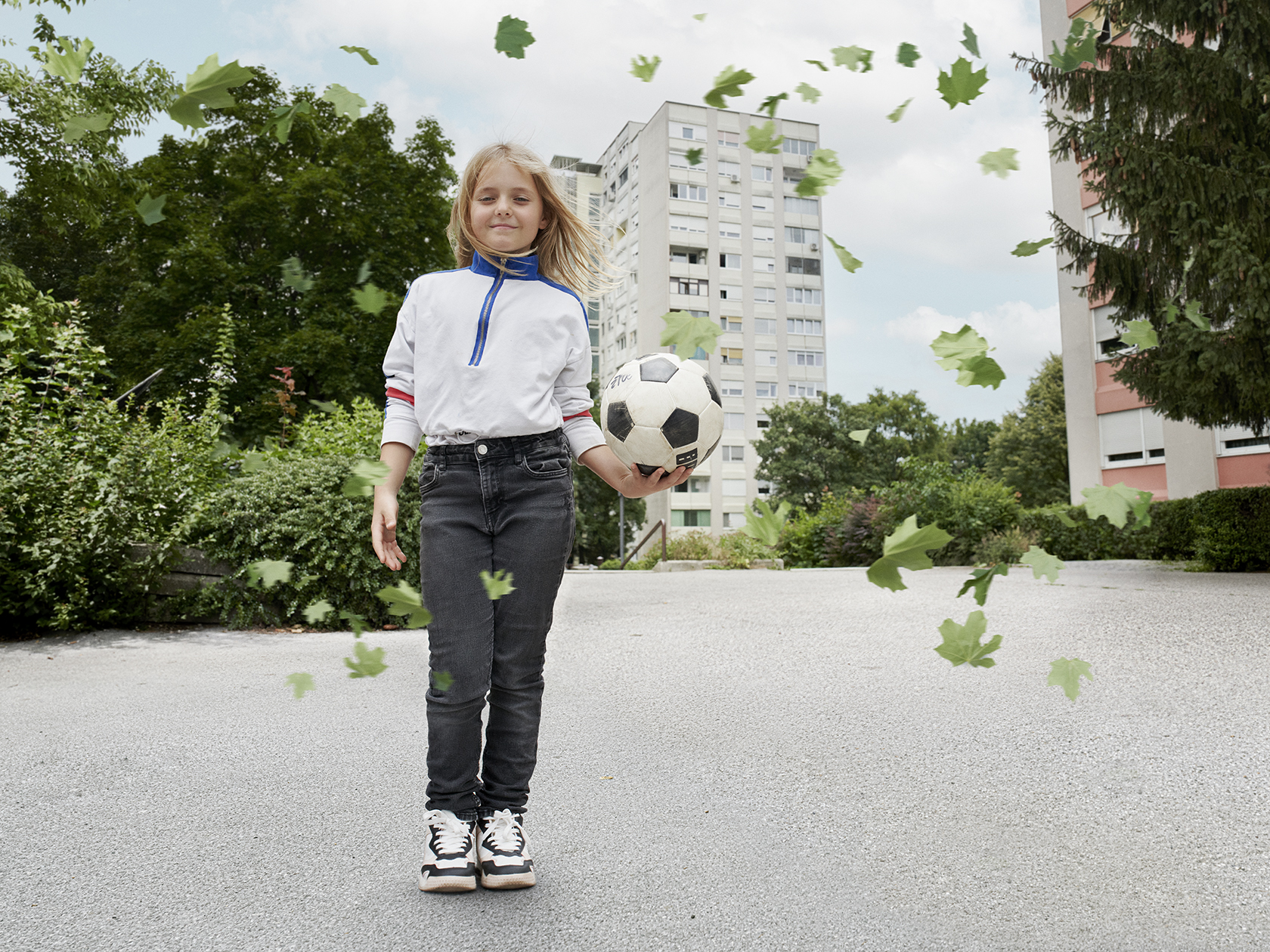 A girl with a football in her hand