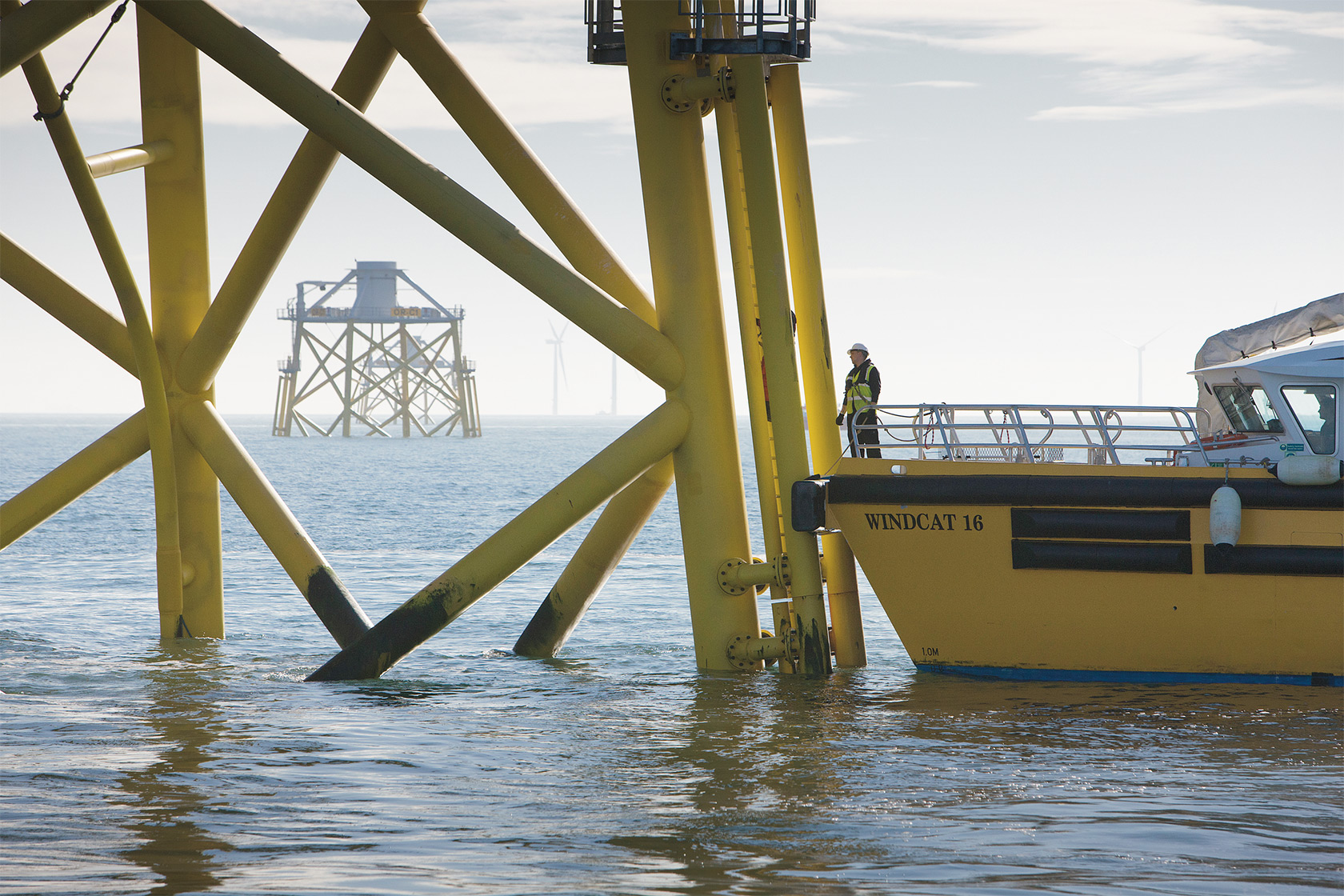 Man on a ship inspecting foundations at Ormonde offshore wind farm