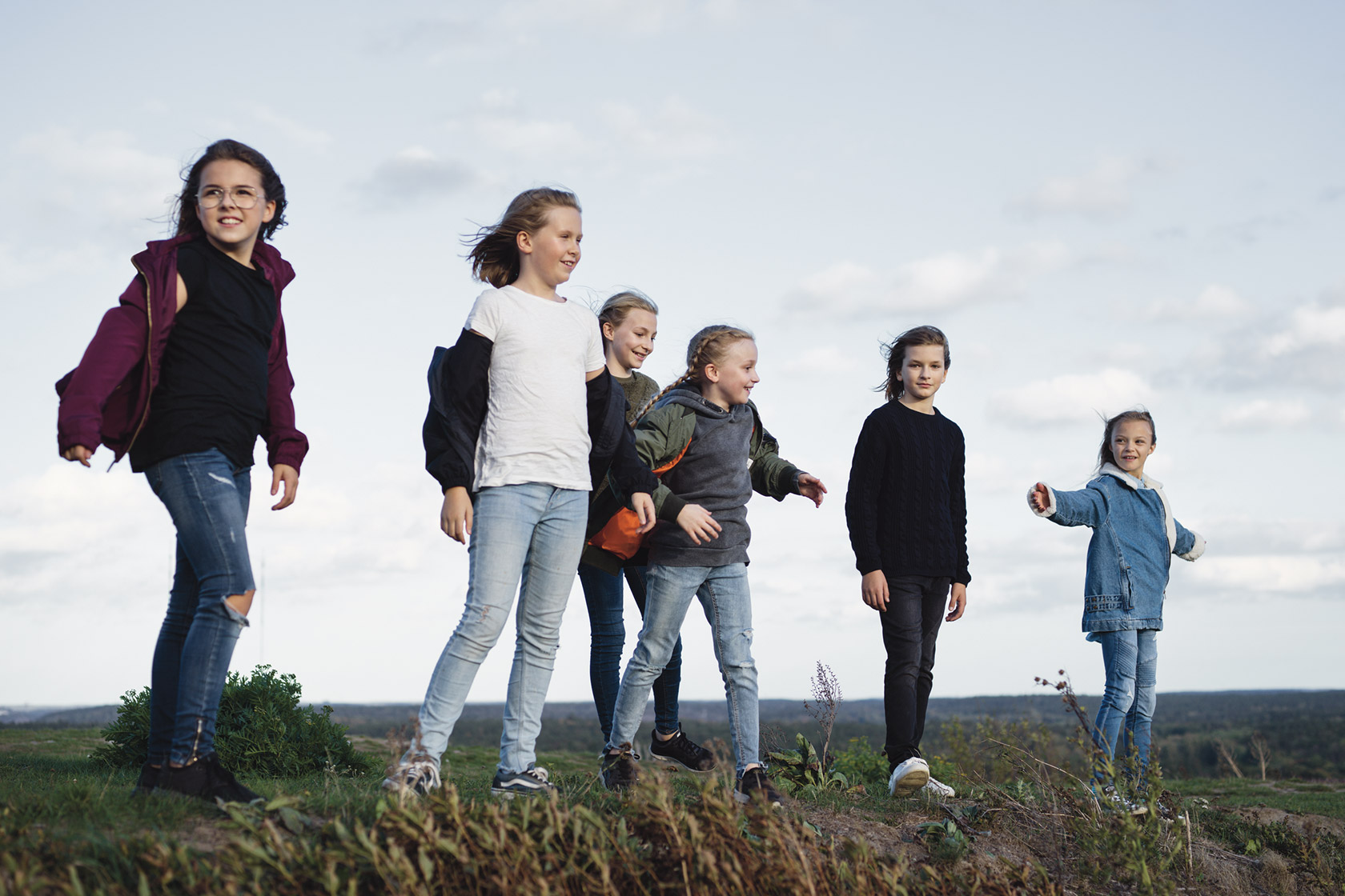 A group of children on a windy hill