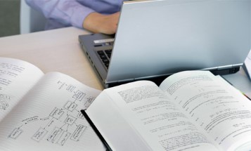 A laptop and documents on a desk