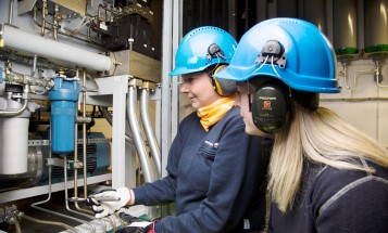 Two women working in a power plant