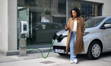 Woman charging an electric car