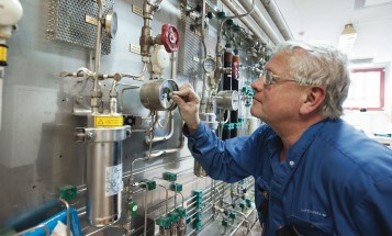 A male employee at Idbäcksverket checking a pressure gauge