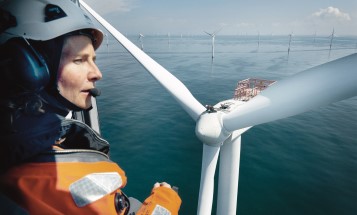 Woman in helicopter looking down on turbines at Horns Rev offshore wind farm