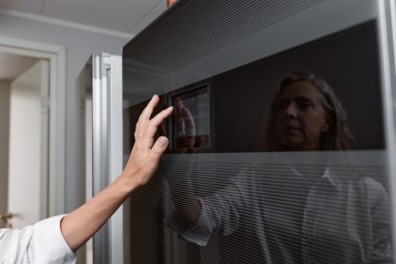 Woman checking oven heat