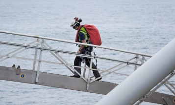 A wind employee carrying equipment