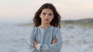 Girl on beach looking into camera