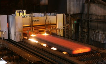 Rolled red-hot steel on conveyor belt