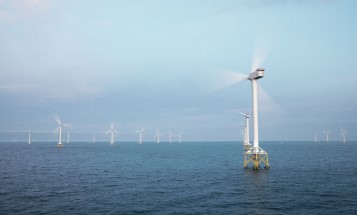 Wind turbines with spinning rotor blades at Ormonde offshore wind farm, United Kingdom.