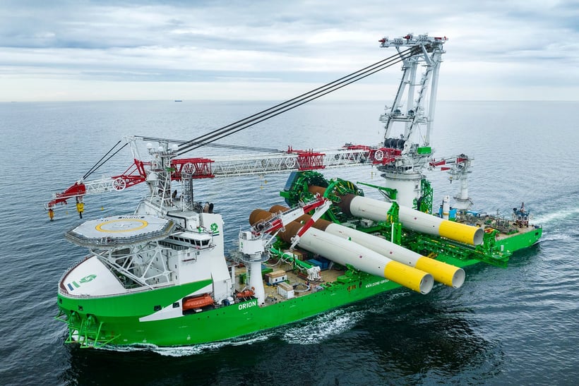 Large DEME offshore installation vessel carrying wind turbine foundations.