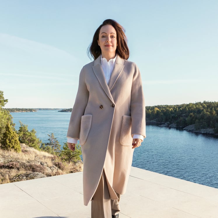 Anna Borg, VD och koncernchef Vattenfall, går mot kameran, med en skärgårdsvy i bakgrunden.