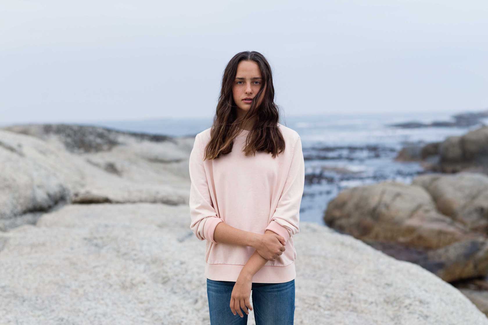 A girl on a rocky beach