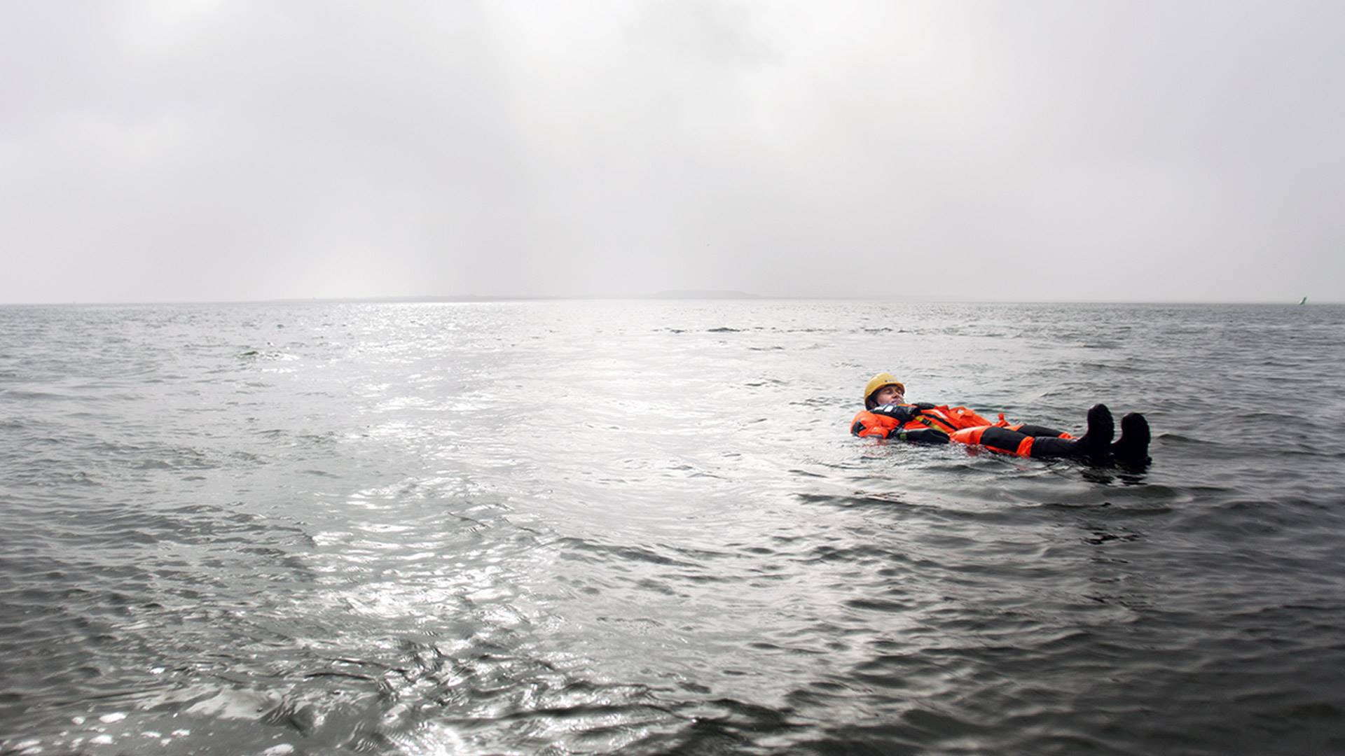 Sea rescue course participant floating at sea