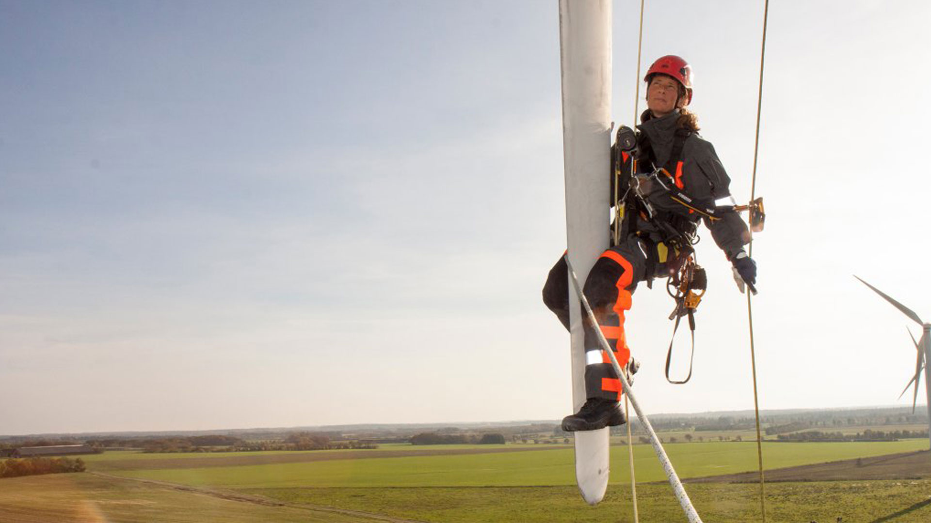 Rikke Juul Balle hanging from a turbine