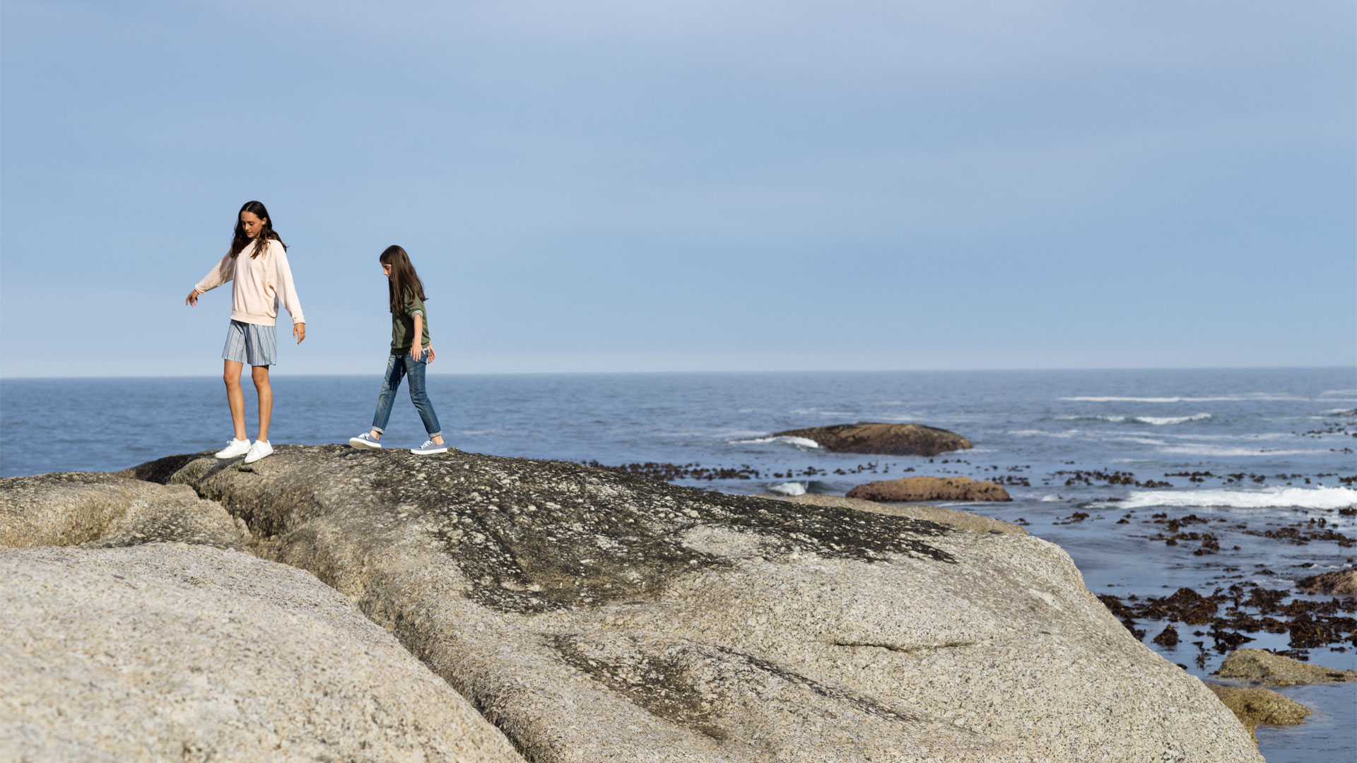 Two girls on rocks by the sea. Photo: Felix Odell