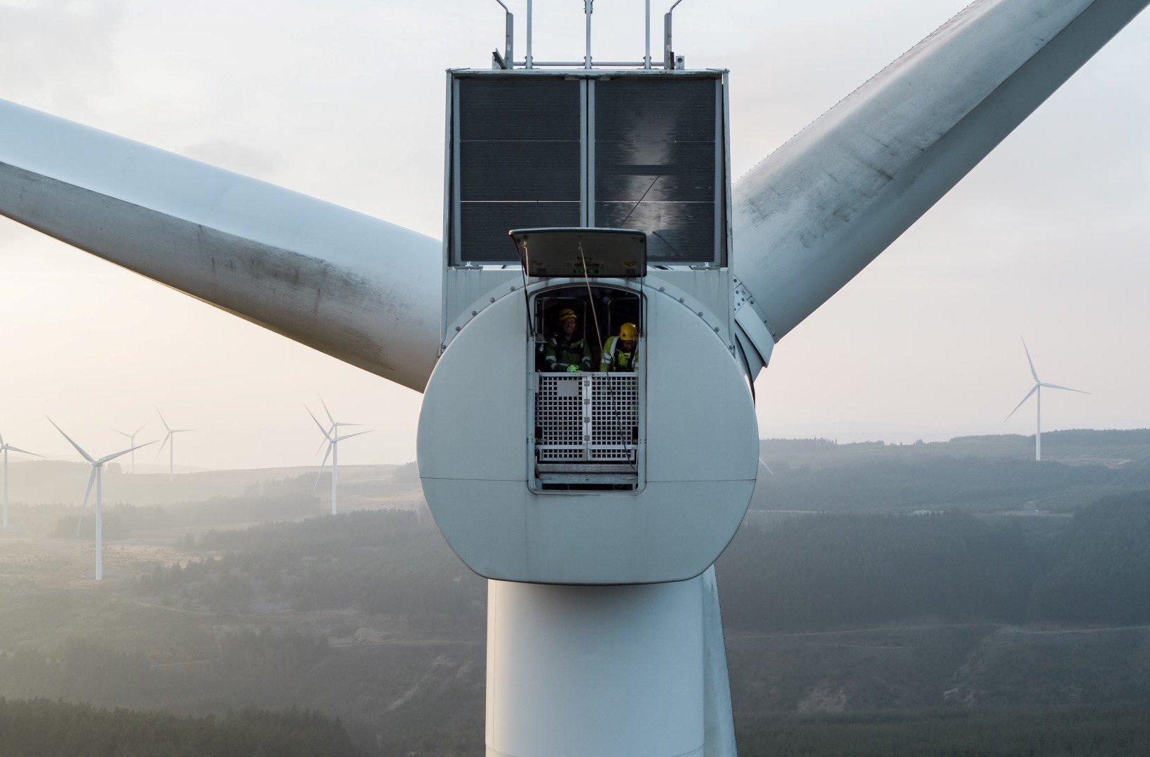 Technicians inside a wind turbine nacelle
