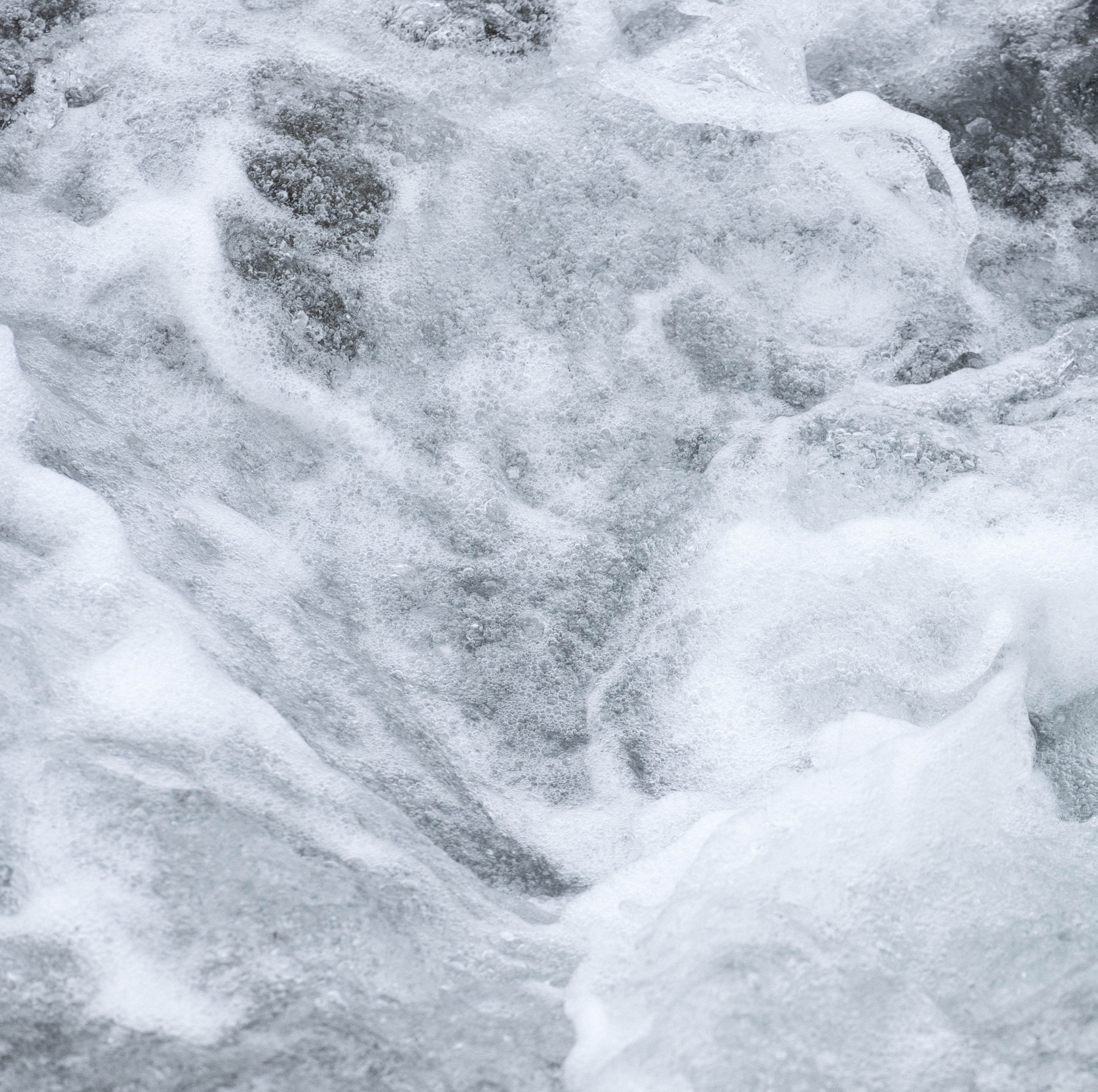 Image of swirly and foaming water in a stream.