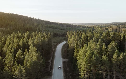 Car driving in northern Sweden on a road. Car driving in northern Sweden on a road.
