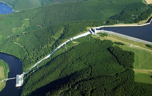 Aerial view of the Hohenwarte II pumped storage power plant and reservoir surrounded by dense forest. Aerial view of the Hohenwarte II pumped storage power plant and reservoir surrounded by dense forest.