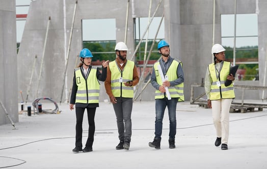 Four people on a construction site Four people on a construction site