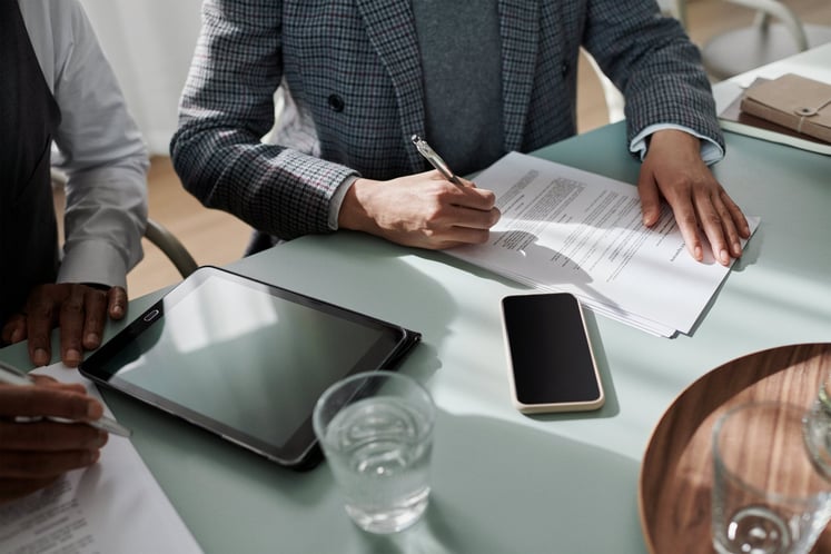 Signing of contracts in an office Signing of contracts in an office