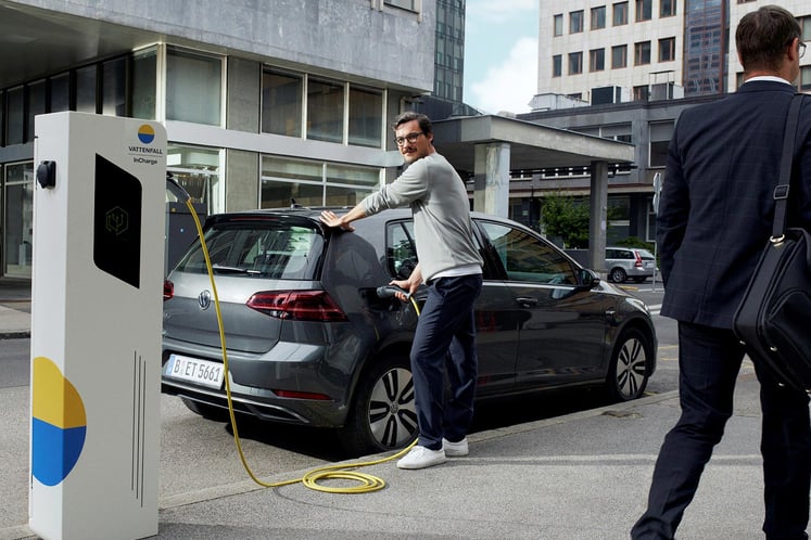 Man charging electric car Man charging electric car