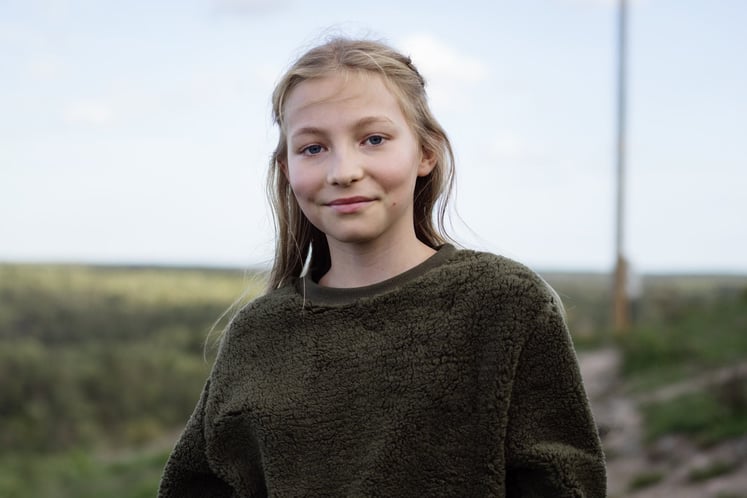 Mädchen mit grünem Pullover in die Kamera blickend Mädchen mit grünem Pullover in die Kamera blickend